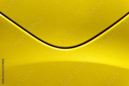 Curves of yellow metal car body. Abstract - steel post envelope.