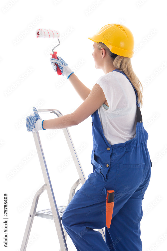 young woman painter in blue builder uniform standing on ladder w young woman painter in blue builder uniform standing on ladder w