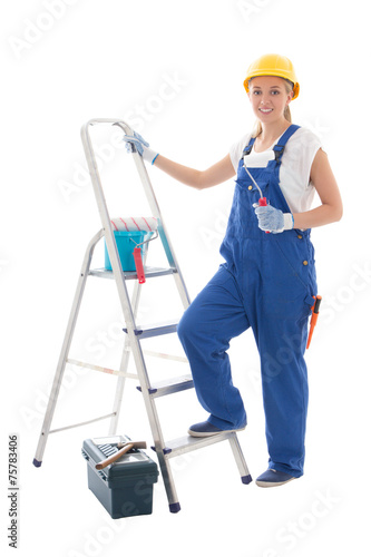 young woman painter in blue builder uniform with ladder and tool