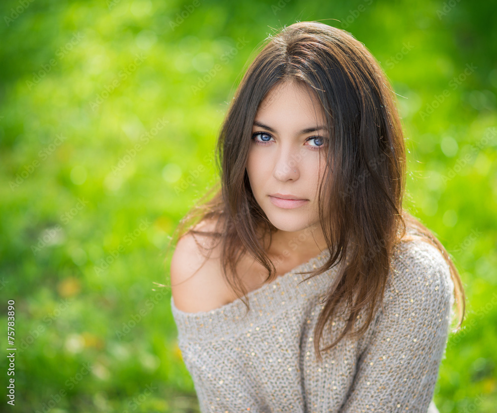 Portrait of young beautiful woman in sweater.