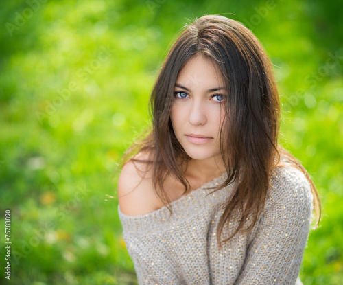 Portrait of young beautiful woman in sweater.