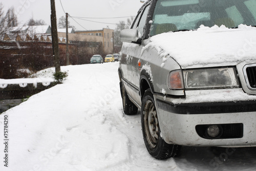 Snow covered car during a snowstorm © patrikslezak