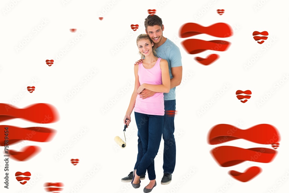 Composite image of young couple painting with roller Composite image of young couple painting with roller
