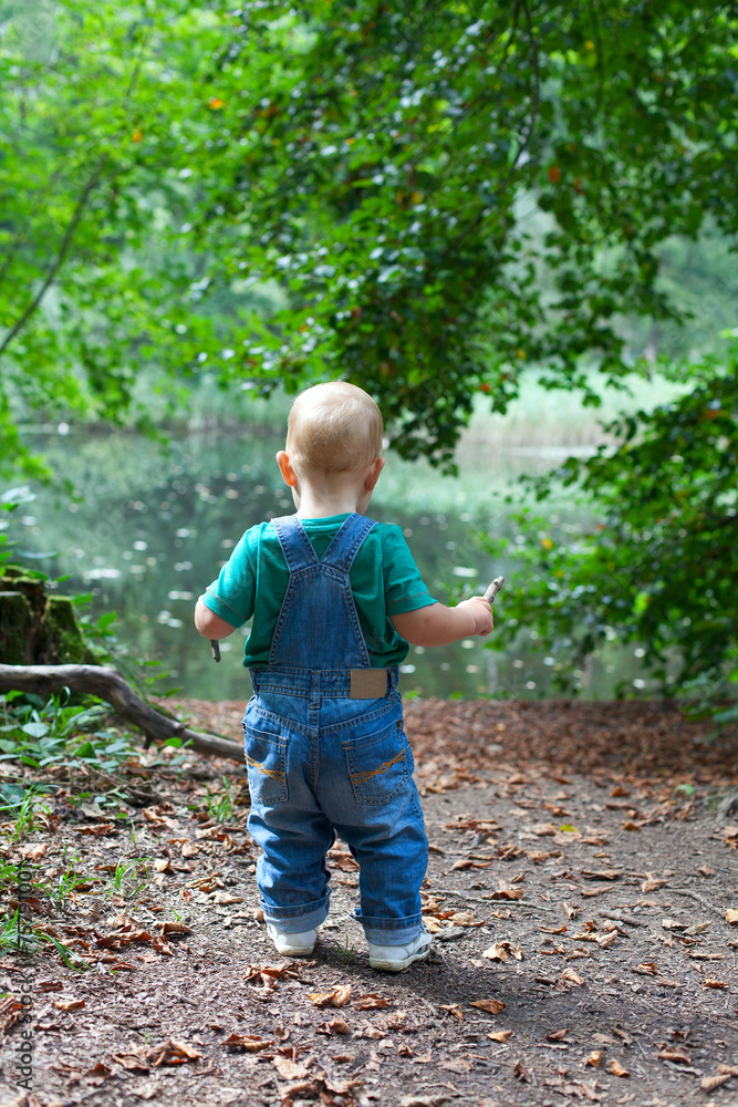 toddler boy having fun in a beautiful summer forest toddler boy having fun in a beautiful summer forest
