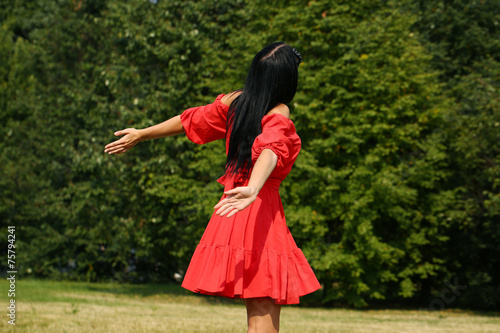 Happy young woman in red dress