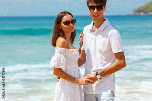 Lovely couple walking on a tropical beach