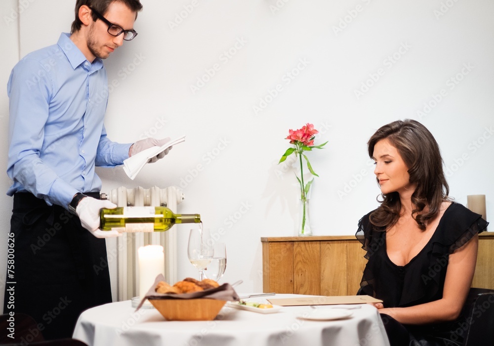 Waiter offering wine to lady in restaurant Waiter offering wine to lady in restaurant