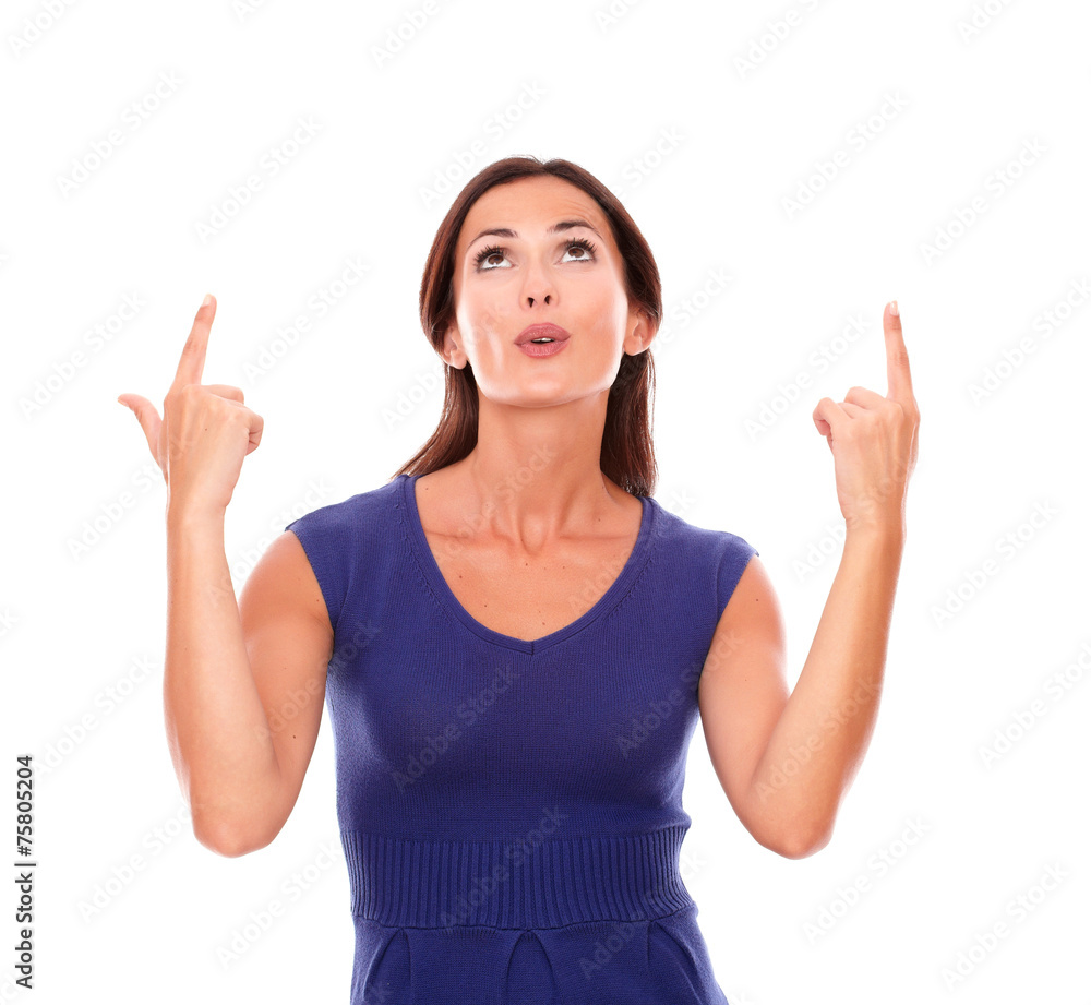 Charming lady looking up and pointing up smiling Charming lady looking up and pointing up smiling