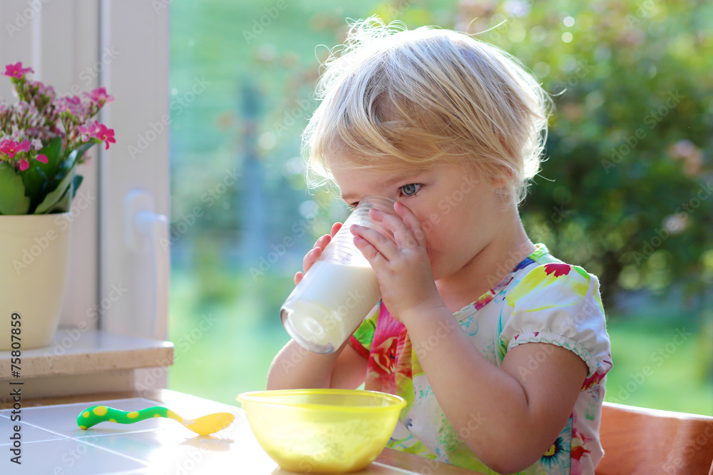 Little girl drinking milk from glass Little girl drinking milk from glass