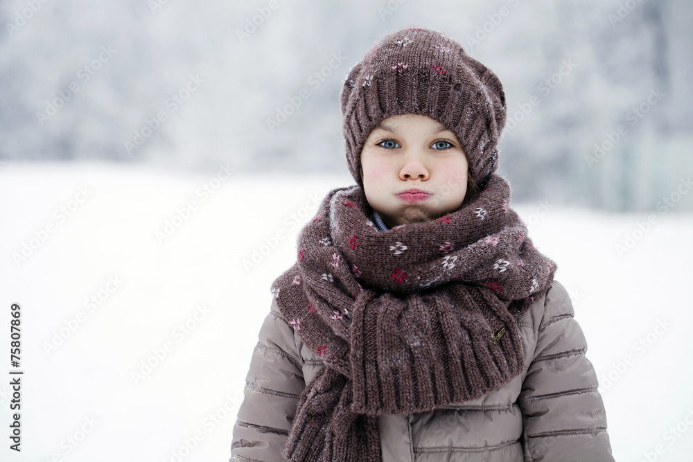 Happy little girl on the background of a winter park Happy little girl on the background of a winter park