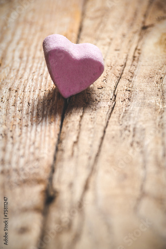 The pink heart on a wooden rustic table as background