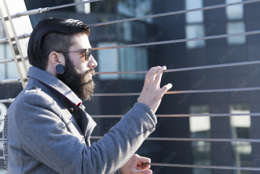 young hipster businessman look at traffic on an iron bridge young hipster businessman look at traffic on an iron bridge