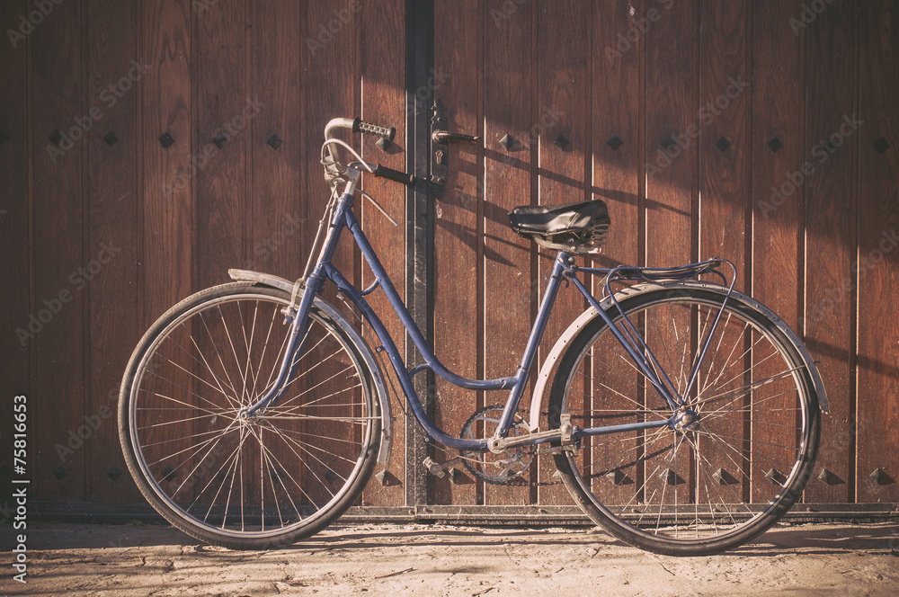 Old or classic bicycle on a wooden door