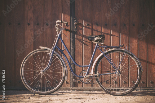Old or classic bicycle on a wooden door © irantzuarb