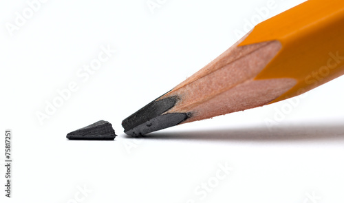 Broken head of sharp pencil on a white paper