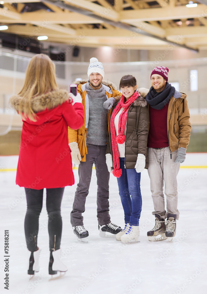 happy friends taking photo on skating rink happy friends taking photo on skating rink