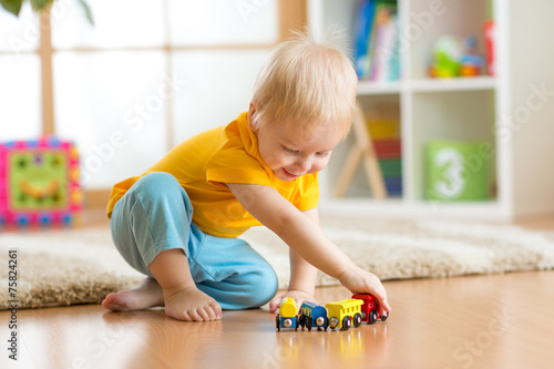 kid boy playing with toys i...