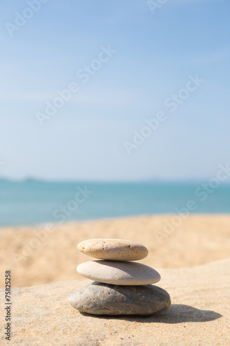 Stones balance, pebbles stack on sunny sea beach
