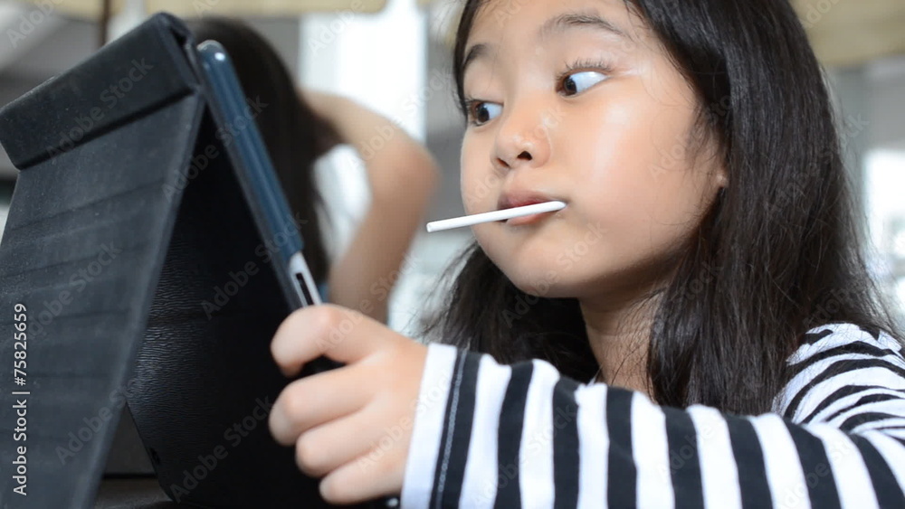 Young Asian child using a digital tablet together . Young Asian child using a digital tablet together .