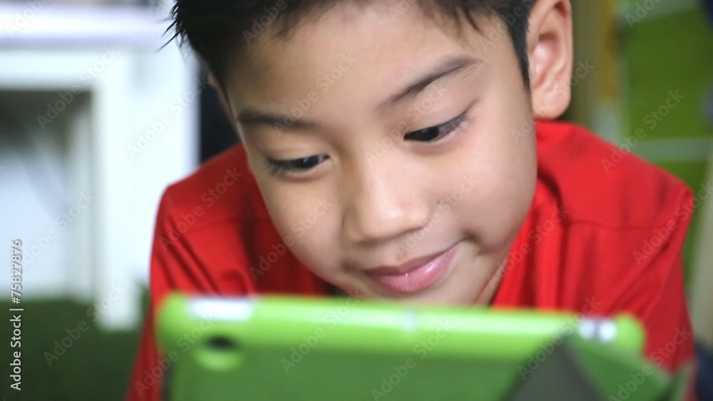 Young Asian child using a digital tablet together . Young Asian child using a digital tablet together .