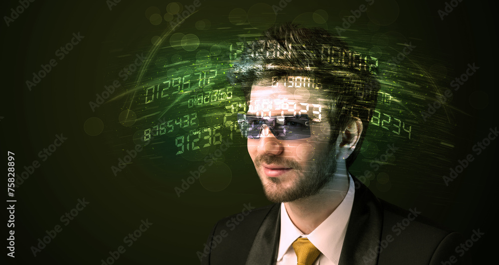 Business man looking at high tech number calculations Business man looking at high tech number calculations