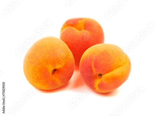 Ripe orange apricots, peaches isolated on white background.