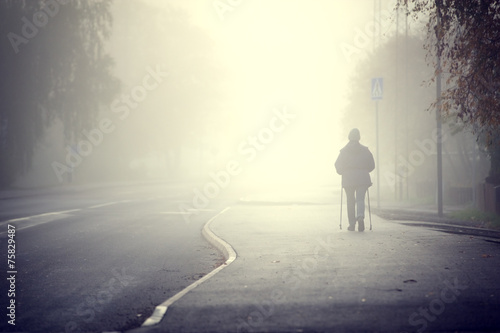 Woman walking in the fog