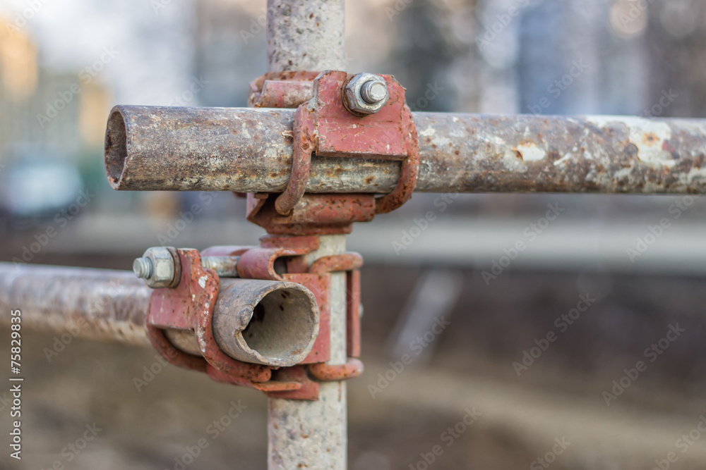 Close of rusty metal scaffolding connector Close of rusty metal scaffolding connector