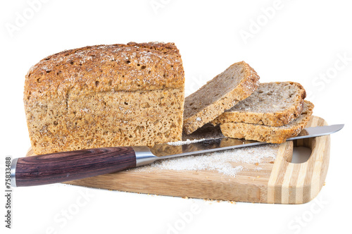 Cut wholemeal bread and knife on a chopping board