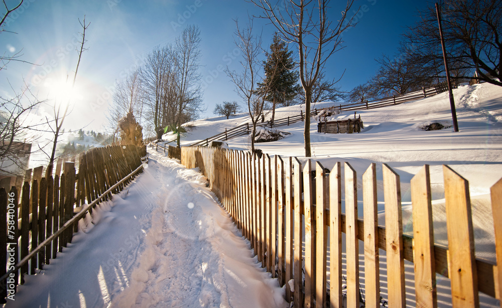 Narrow road covered by snow at countryside. Winter landscape Narrow road covered by snow at countryside. Winter landscape