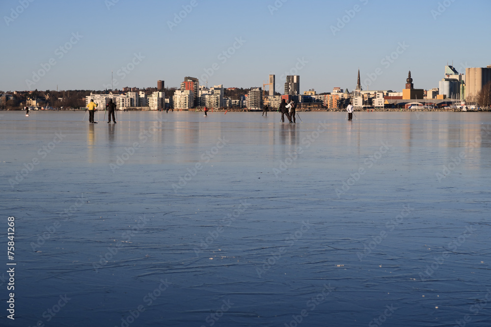 Ice skating with Vasteras skyline in the background.