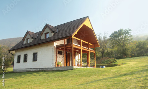 house on green meadow with blue sky