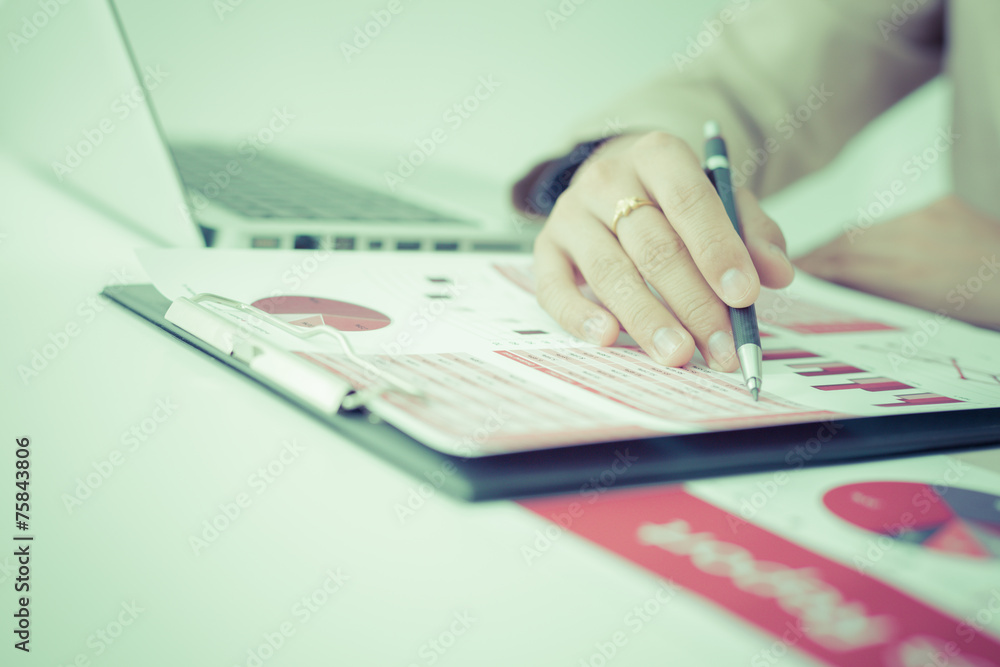 woman hand with business report woman hand with business report