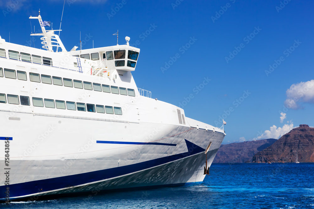 Modern cruise ship sailing on Aegean sea, Santorini Greece.