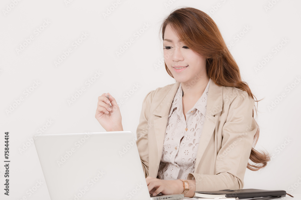 Portrait of a young business woman using laptop at office Portrait of a young business woman using laptop at office