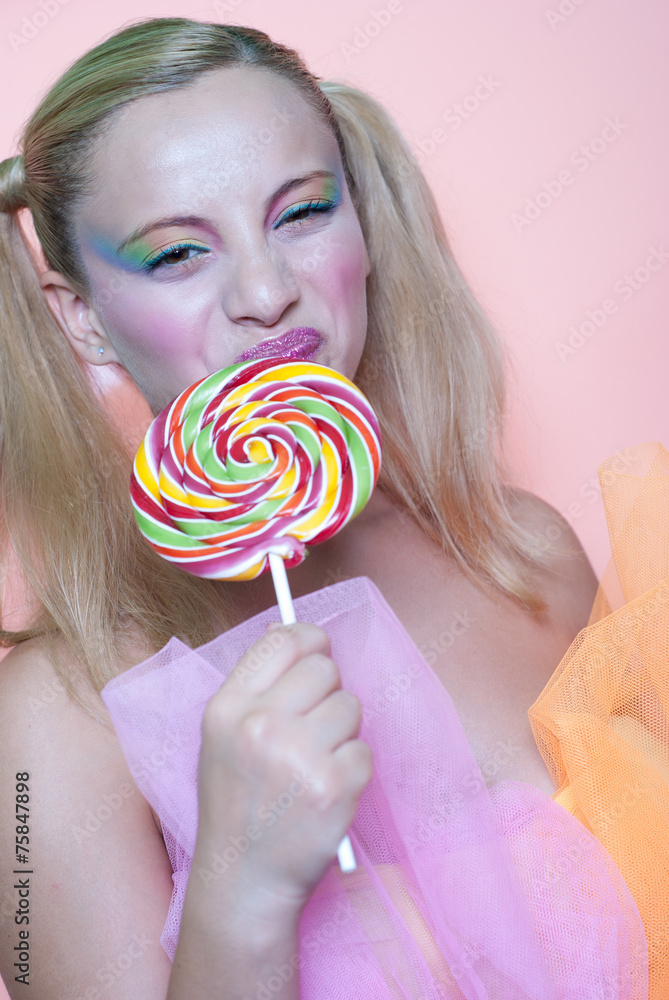 Sweet Greek girl holding a lollipop heart