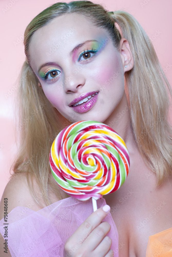 Sweet girl holding a lollipop heart