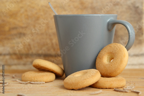 Mug of milk with biscuits and bran sticks photo