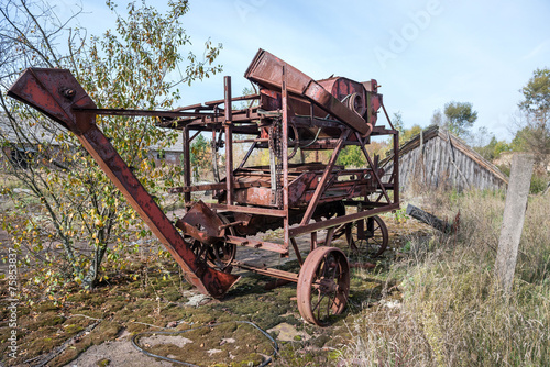 old thrashing machine in kolkhoz near Korohod in Chernobyl Zone