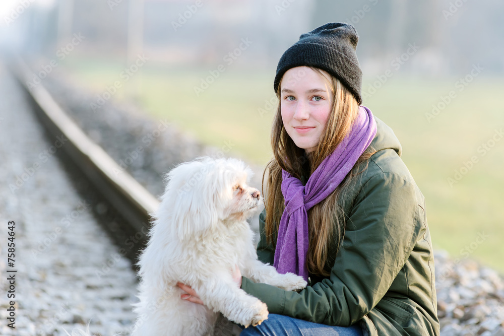 Girl with dog playing on the railroad Girl with dog playing on the railroad