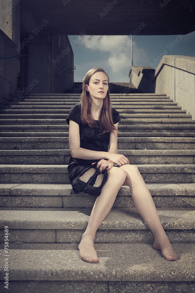Brunette lady posing on city building location Brunette lady posing on city building location