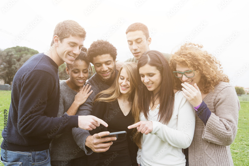 Obraz premium Multiethnic Group of Friends Looking at Mobile Phone