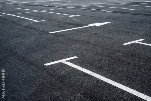 Asphalt surface of the parking with road marking lines
