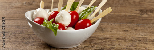 Caprese salad on a sticks with mozzarella, tomatoes and basil