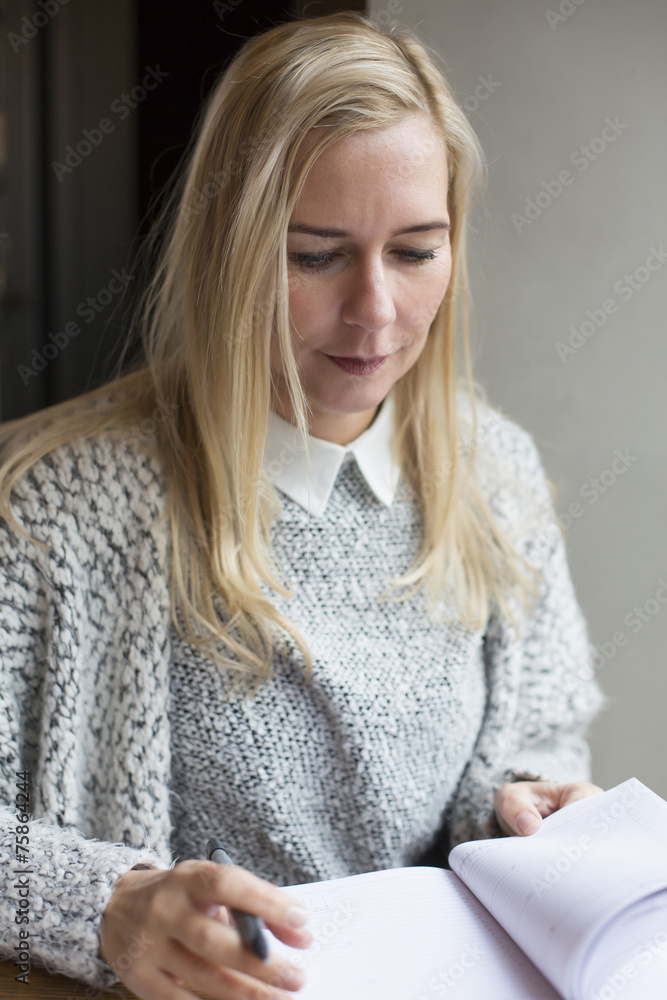 woman writing in a book woman writing in a book
