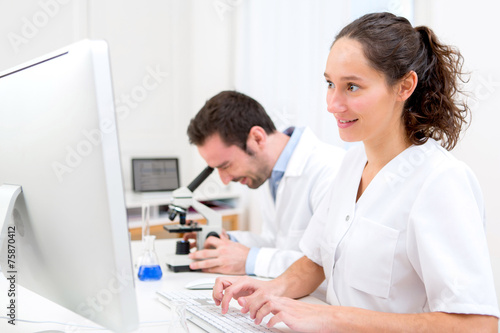 Scientist and her assistant in a laboratory