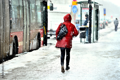 Photography Commuter running to bus in snowstorm