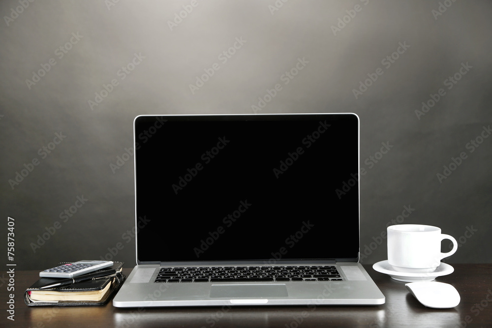 Fototapeta premium Modern laptop on table, on grey background