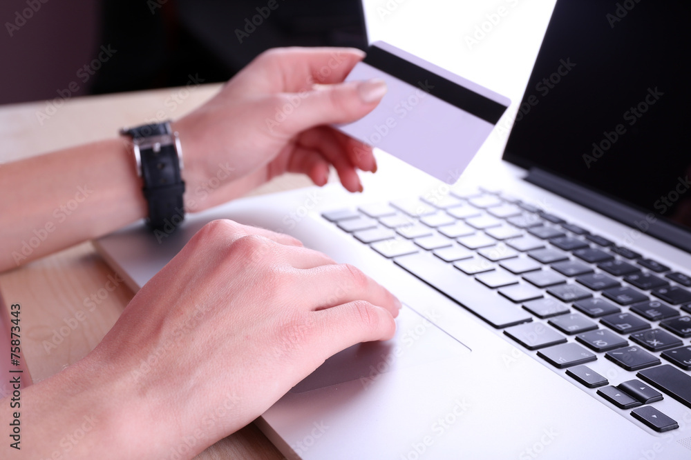 Concept for Internet shopping: hands with laptop and credit Concept for Internet shopping: hands with laptop and credit