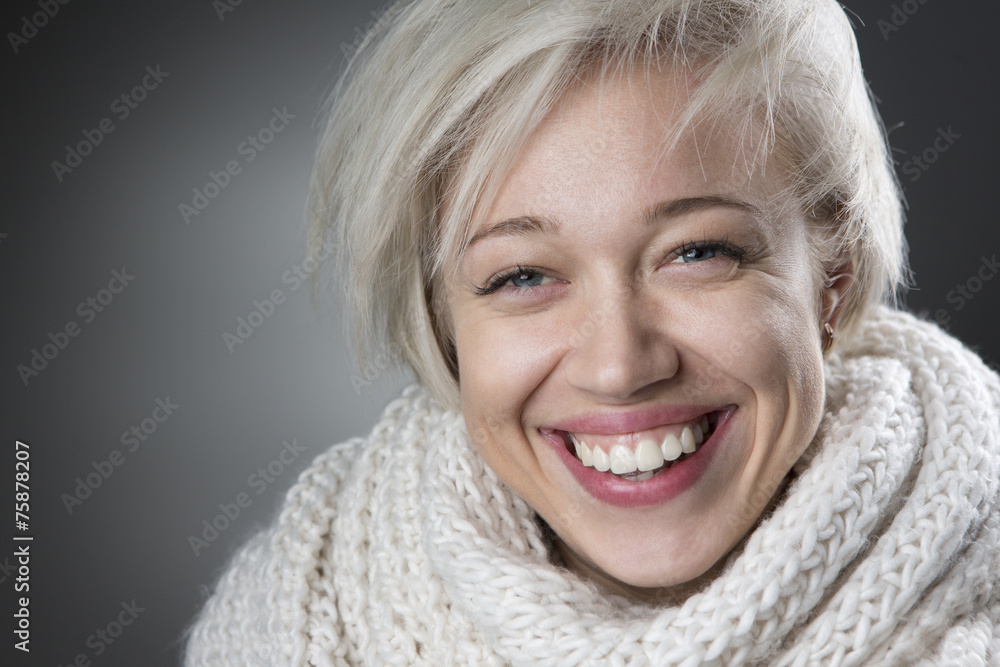 Attractive blond smiling in volumetric white scarf. Attractive blond smiling in volumetric white scarf.